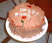 A birthday cake with chocolate icing.