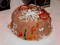 Round cake with chocolate icing and neon-colored decorations