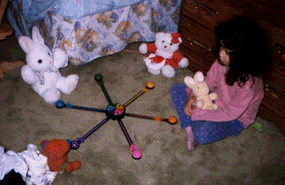 Miranda playing quizbowl with her stuffed animals.